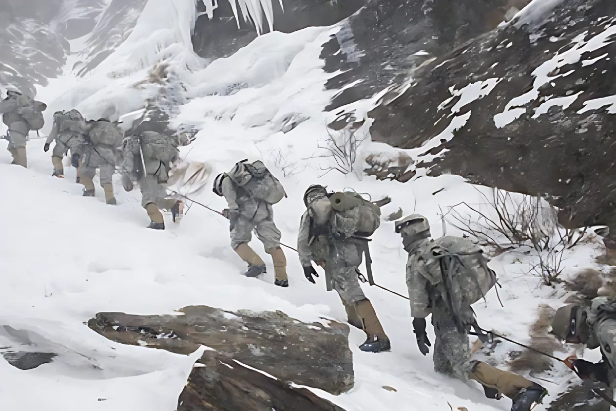 A column of soldiers climbing a snowy slope under heavy packs
