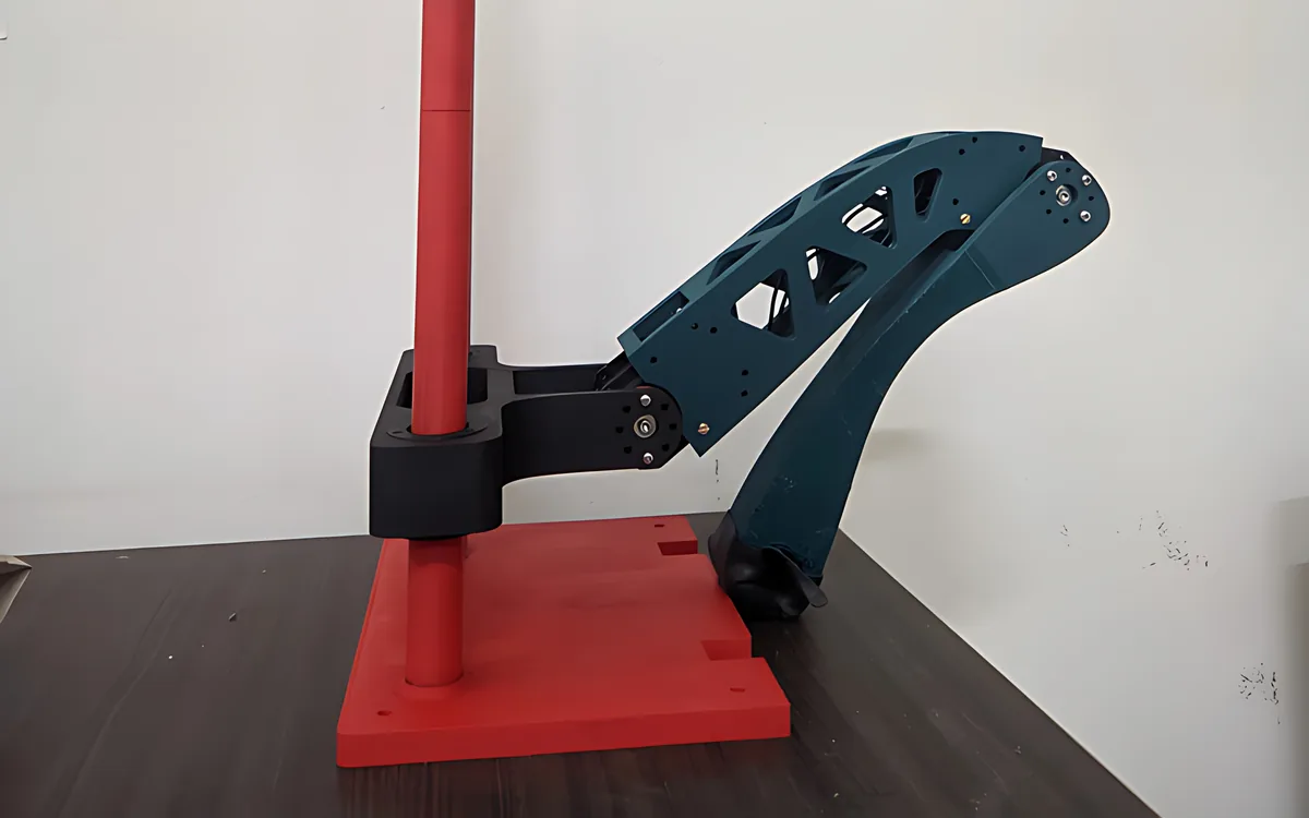 A SUNAC leg mounted on a red test rig in the lab